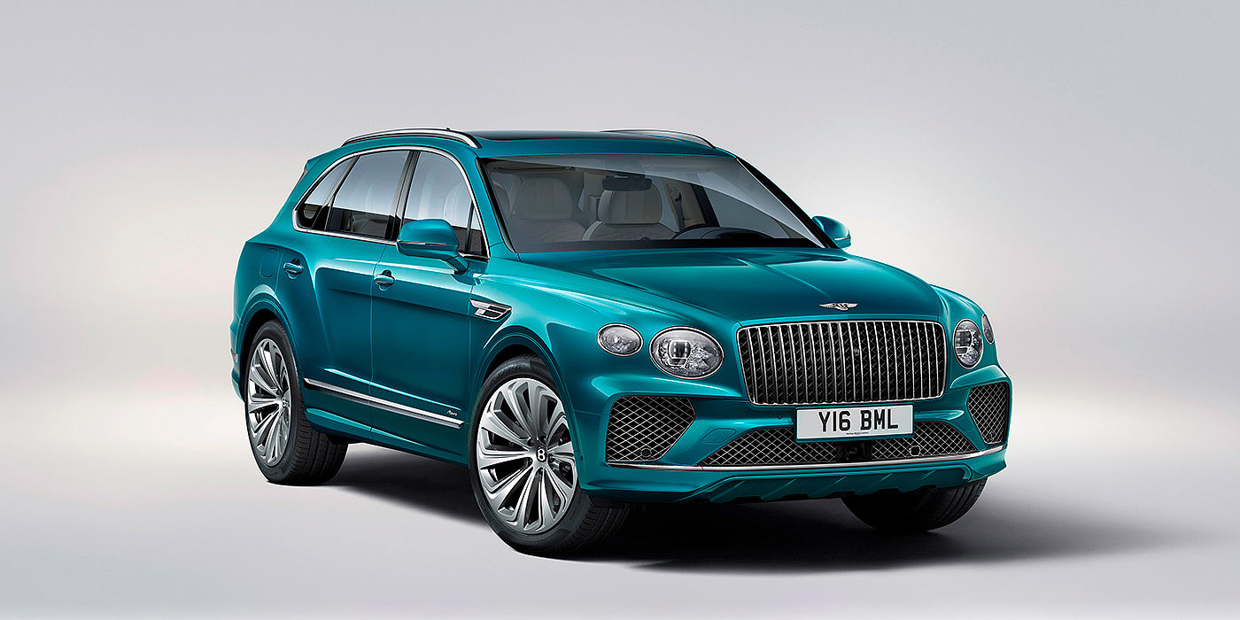 Bentley Valencia Bentley Bentayga Azure front three-quarter view, featuring a fluted chrome grille with a matrix lower grille and chrome accents in Topaz blue paint.