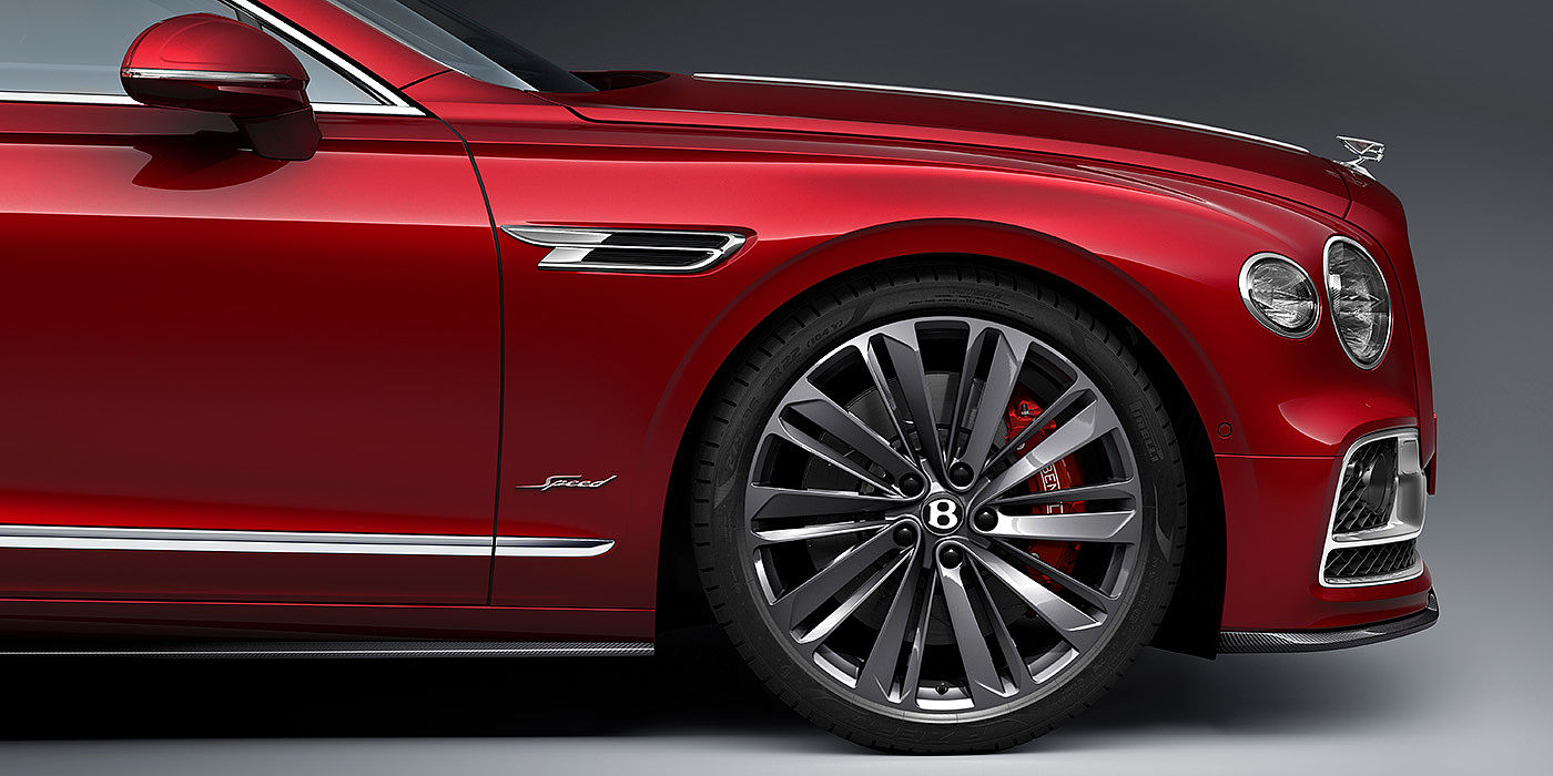 Bentley Valencia Bentley Flying Spur Speed sedan front wheel in close up with Dragon Red II paint