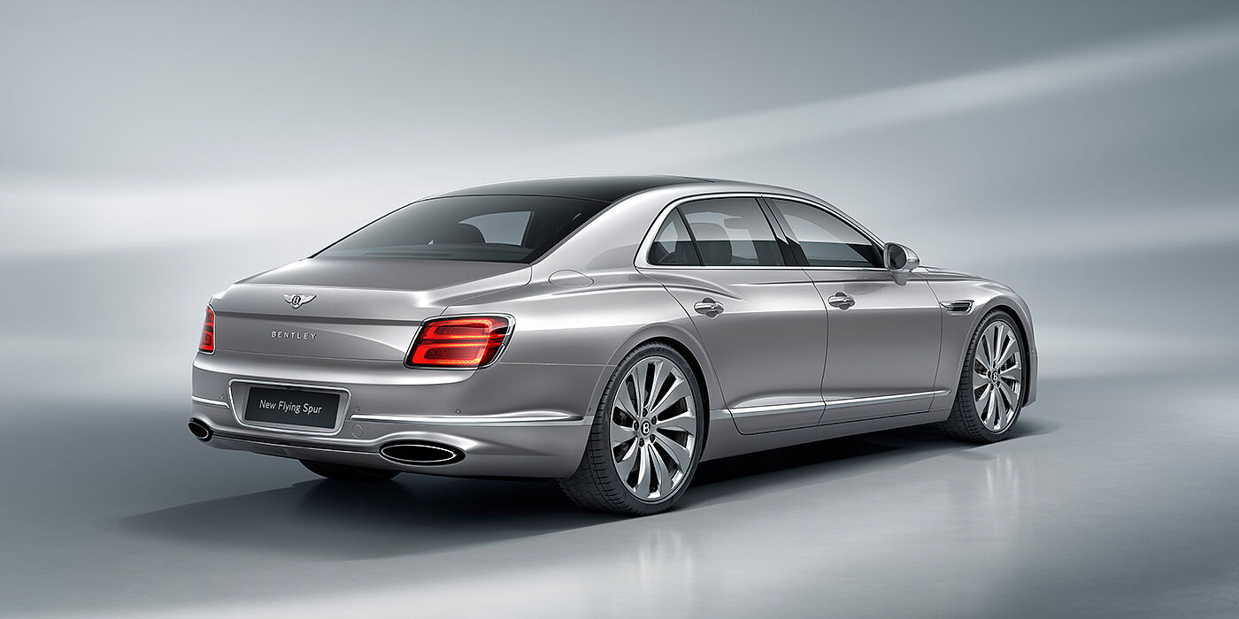 Bentley Valencia New Bentley Flying Spur sedan rear view in Silverlake paint with ten spoke wheels and chrome matrix grille
