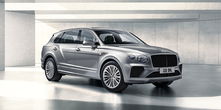 Bentley Valencia Bentley Bentayga Extended Wheelbase SUV front three quarter in Moonbeam paint with a grey background
