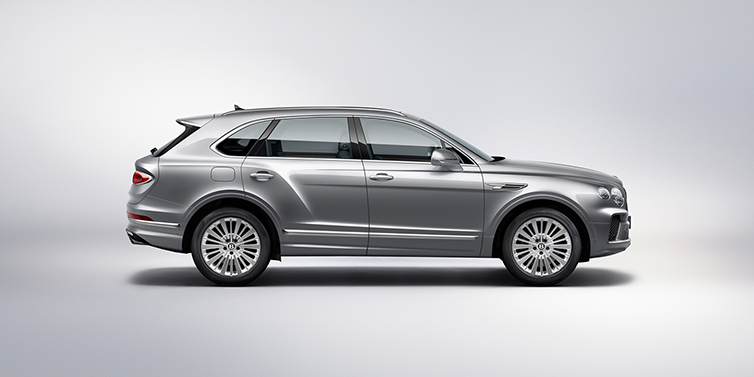 Bentley Valencia Bentley Bentayga SUV side profile in Moonbeam silver paint against white background featuring 21 inch 5 spoke wheels