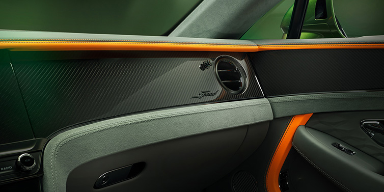 Bentley Valencia Bentley Continental GT Speed coupe front interior dash detail with high gloss carbon fibre veneer surrounded by Mandarin by Mulliner and Gravity Grey hides