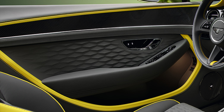 Bentley Valencia Bentley Continental GTC Speed convertible interior door details featuring Gravity Grey and Cyber Yellow by Mulliner hides and high gloss carbon fibre veneer