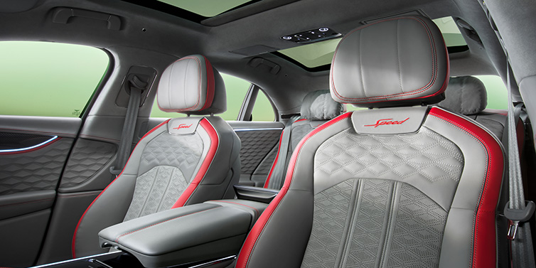 Bentley Valencia Bentley Flying Spur Speed sedan interior showing front and rear seats in Hotspur red and Gravity Grey hides, with Speed seat emblems