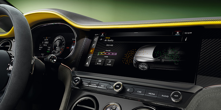 Bentley Valencia Bentley Continental GTC Speed convertible front interior centre console with MMI screen showing Air Quality visualisation surrounded by Cyber Yellow by Mulliner and Gravity Grey hides and high gloss carbon fibre veneer