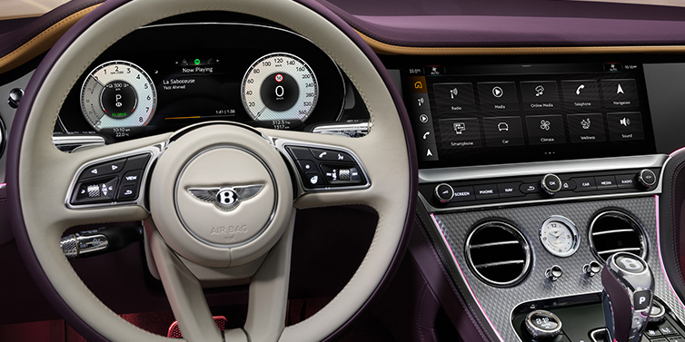 Bentley Valencia Bentley Continental GTC Mulliner convertible steering wheel and drivers screens surrounded by Damson purple and Linen hides